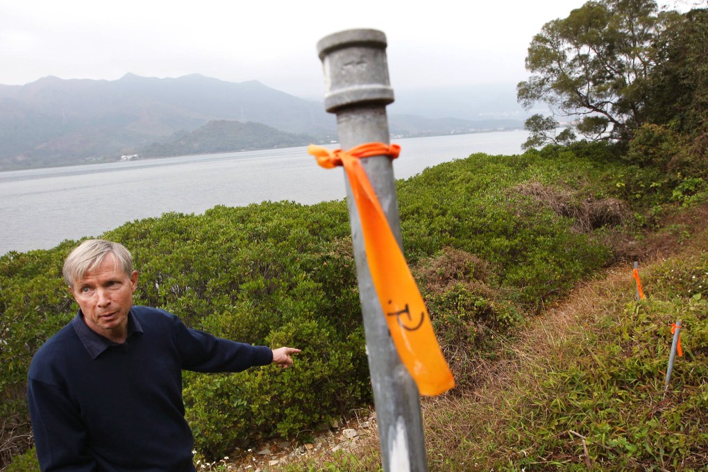 Dr William Butcher, a Luk Keng resident, shows where the path meets the land marked off for building, with Starling Inlet behind him. Photo: Felix Wong