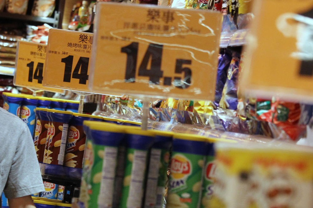 A shopper makes his way through Festival Walk's Taste supermarket in Kowloon Tong. Prices of goods sold at supermarkets rose much less last year than in previous years. Photo: Dickson Lee