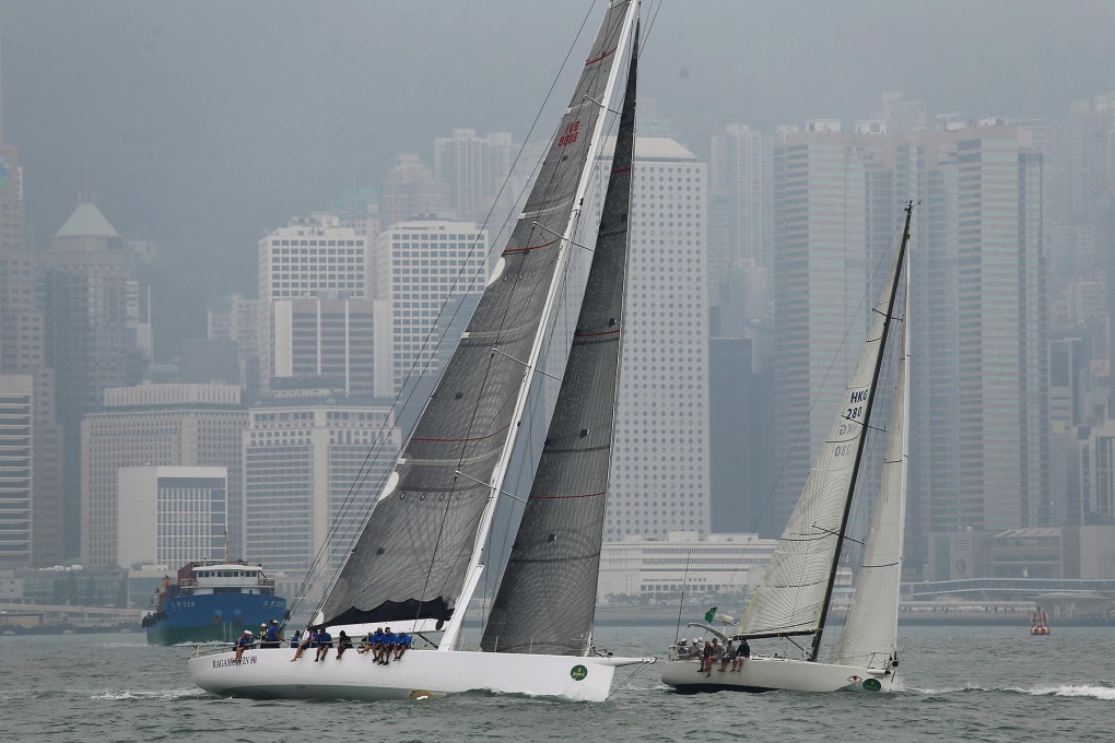 Ragamuffin90 and Redeye sail out in grey conditions from the Royal Hong Kong Yacht Club in Causeway Bay on Wednesday. Photo: K.Y. Cheng