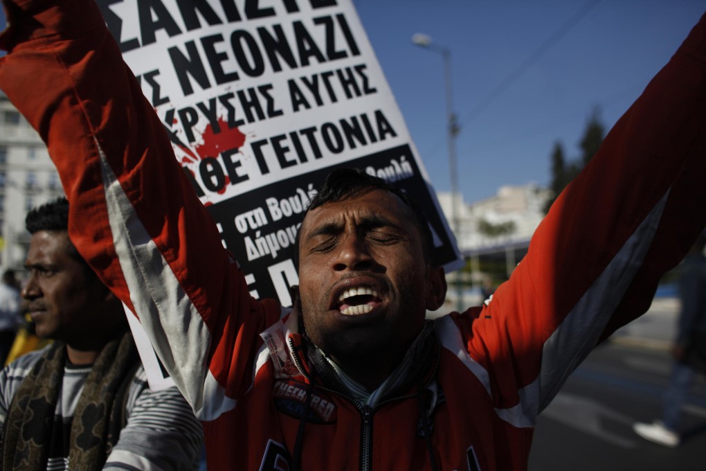 Immigrants fight back at an anti-racism rally in Athens. Photo: AP
