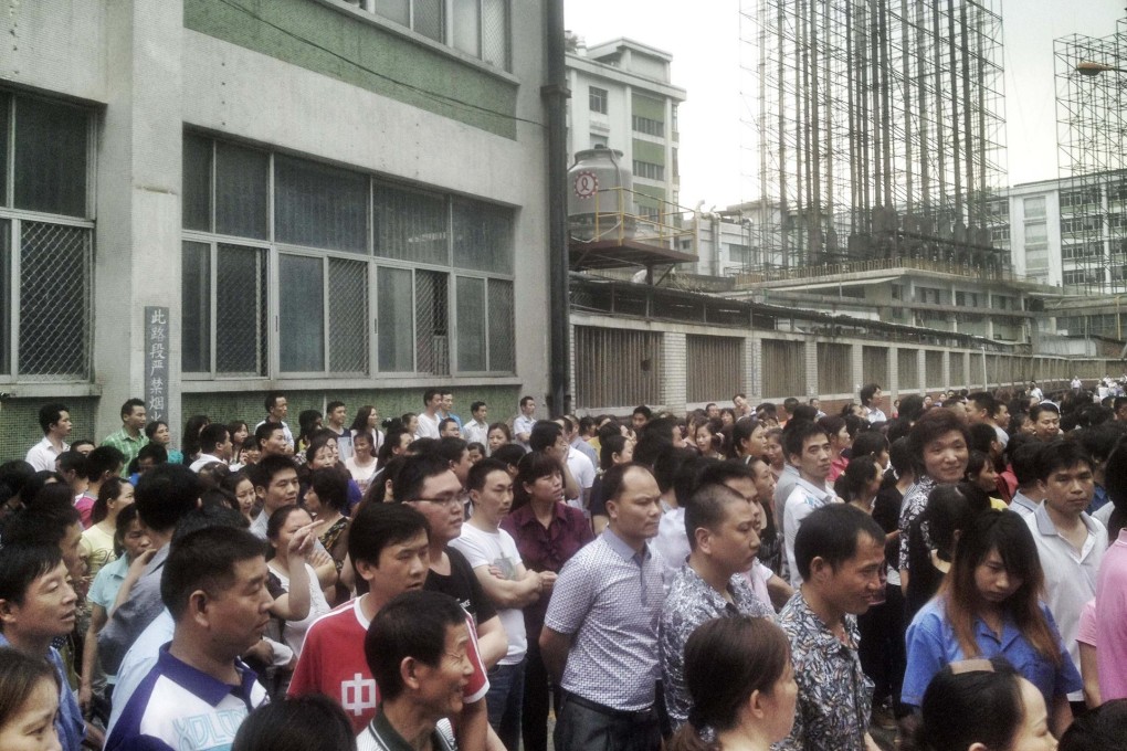 Workers gather at Yue Yuen's Dongguan factory. Photo: Reuters