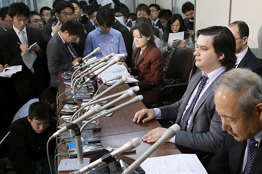Mt. Gox CEO Mark Karpeles (second right) attends a press conference at the Justice Ministry in Tokyo in February. Japanese legal experts say it would be difficult to prosecute Mt. Gox because its business falls outside the boundaries of existing regulations. Photo: AP