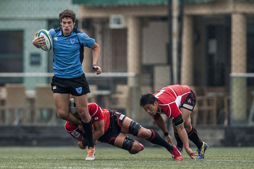 On day one of the 2014 IRB Junior World Rugby Trophy, sixth-seeded Uruguay (wearing blue) beat third seeds Japan, 33-28. Photos: HKRFU