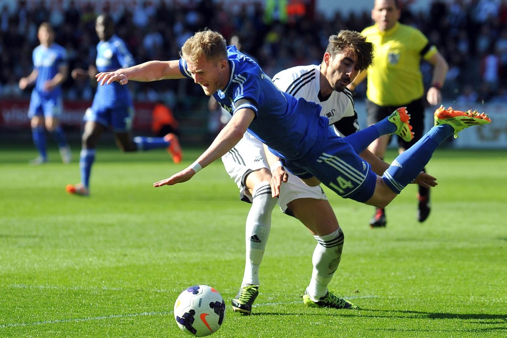Chelsea striker Andre Schurrle is tackled in a match against Swansea on April 13, but on Saturday they host Sunderland. Photo: AFP