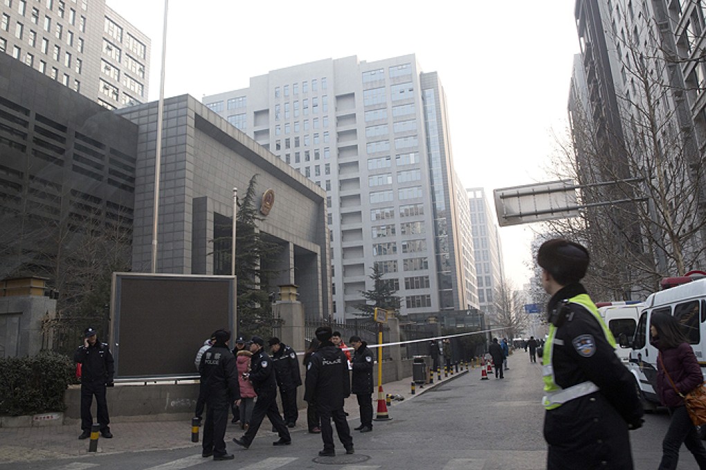 Police stand guard near the Haidian District Court in Beijing where the New Citizens' Movement activists were sentenced. Photo: AP