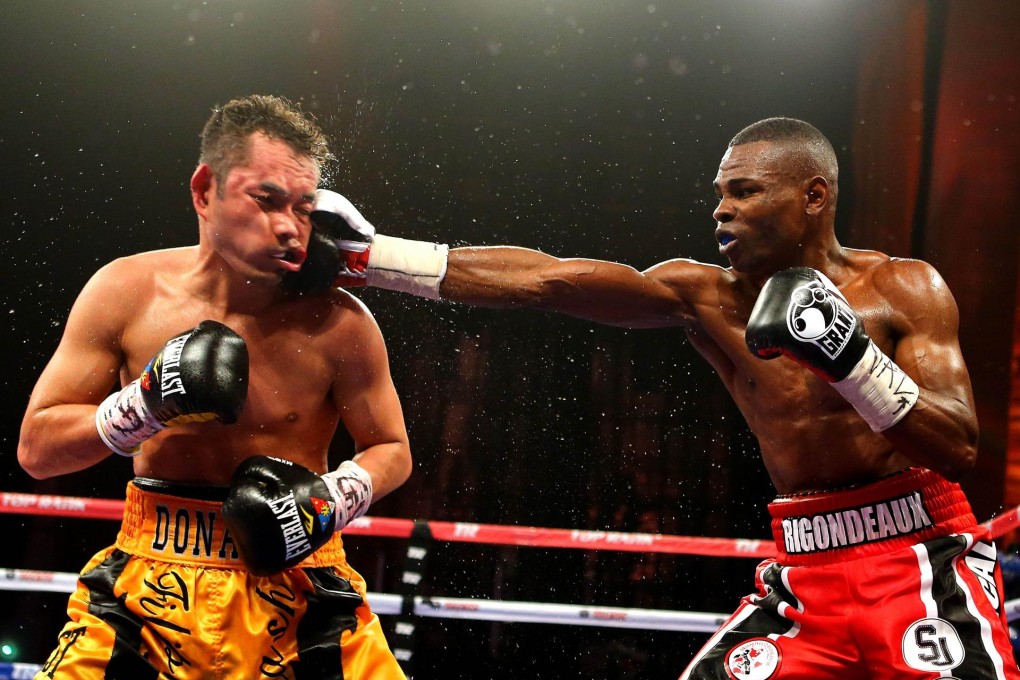 Nonito Donaire can take punishment, as shown when he takes a punch in losing by unanimous decision to Cuban Guillermo Rigondeaux in a world title fight. Photos: AFP
