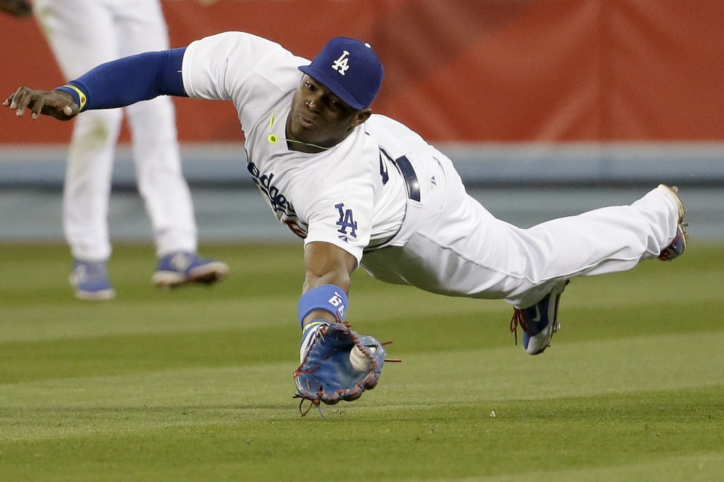 Los Angeles Dodgers right fielder Yasiel Puig fields a base hit. His story is likely to become a movie and not just because of his baseball talent. Photo: AP