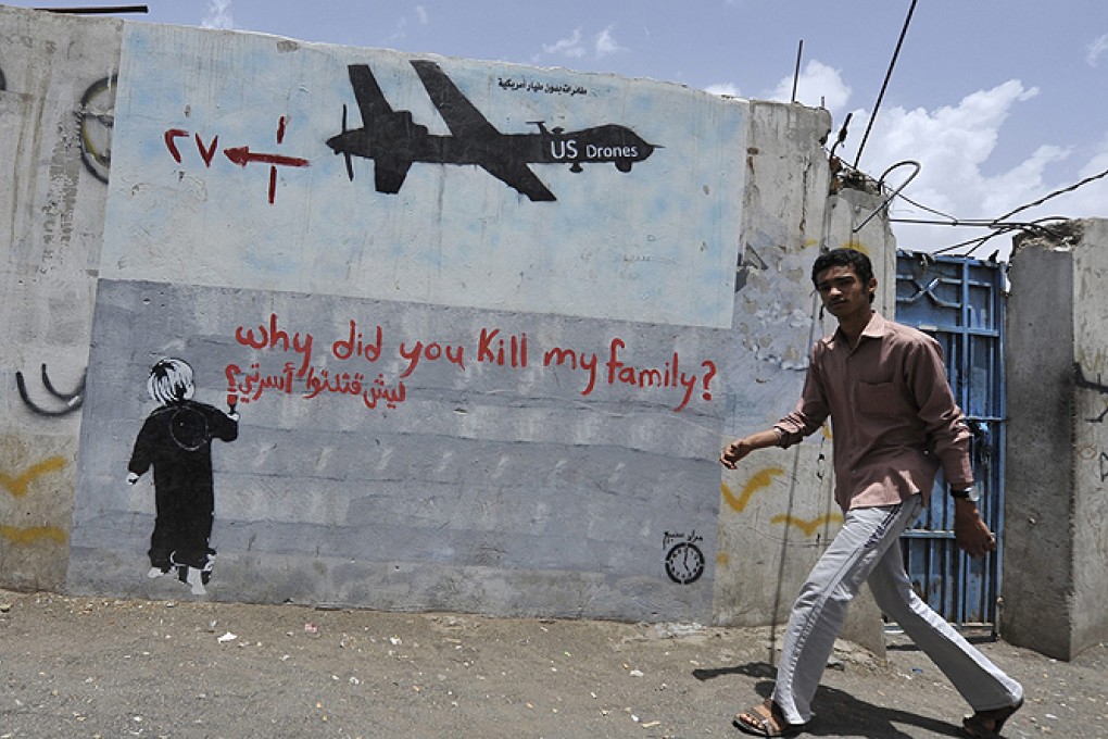 A Yemeni man walks near a graffiti protesting against US drone operations, in Sanaa earlier this month. Photo: EPA