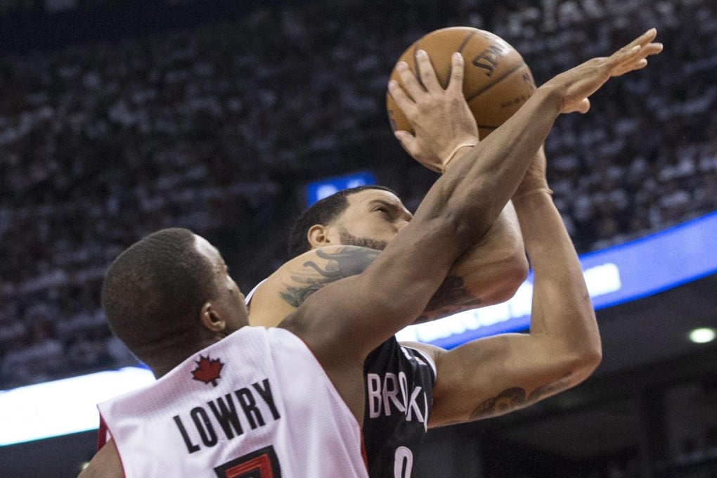 Nets' Deron Williams shoots over Raptors' Kyle Lowry in their play-off opener in Toronto. Williams had a game-high 24 points. Photo: AP