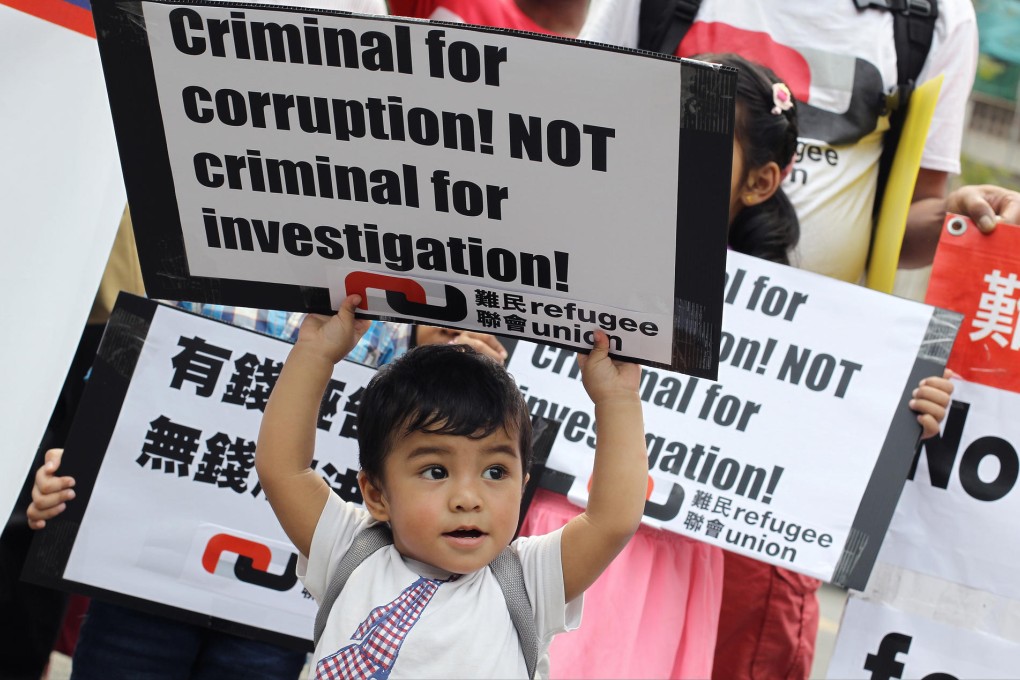 A one-year-old from Nepal attends yesterday's rally against the defamation lawsuit by ISS-HK. Photo: Dickson Lee