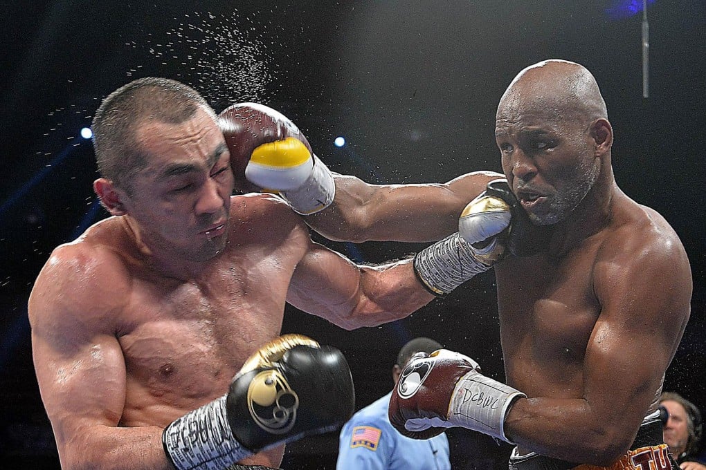 Bernard Hopkins takes a glancing blow but puts a shot on Beibut Shumenov in their light-heavyweight bout in Washington. Photos: AFP