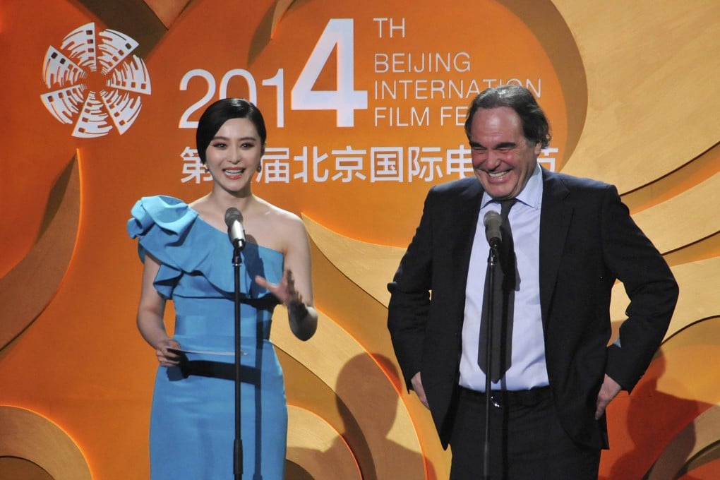 US director Oliver Stone laughs as Chinese actress Fan Bingbing speaks during the opening ceremony of the 4th Beijing International Film Festival in Beijing. Photo: Reuters