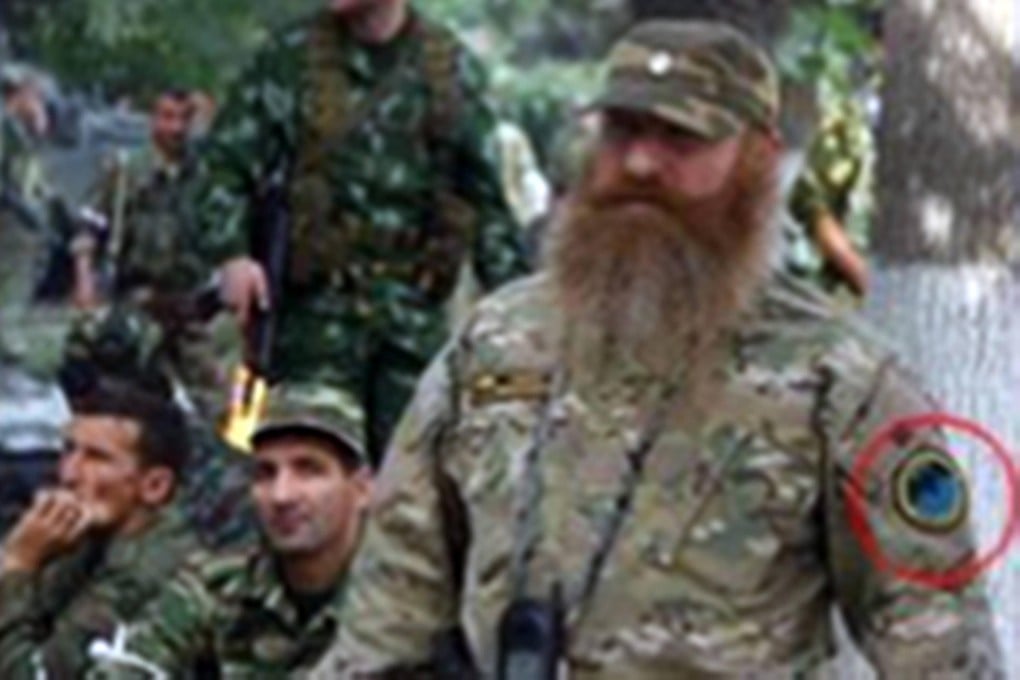 A bearded man bearing the insignia of a Russian unit in Georgia in 2008 (left) and in Kramatorsk, Ukraine, last week.Photos: SCMP Pictures