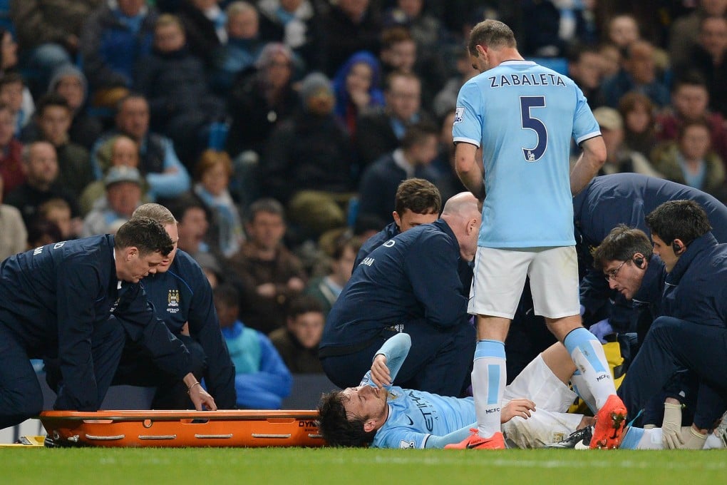 Medical staff prepare to stretcher off Manchester City's  David Silva  following a clash with West Bromwich Albion's  Morgan Amalfitano. Photo: AFP
