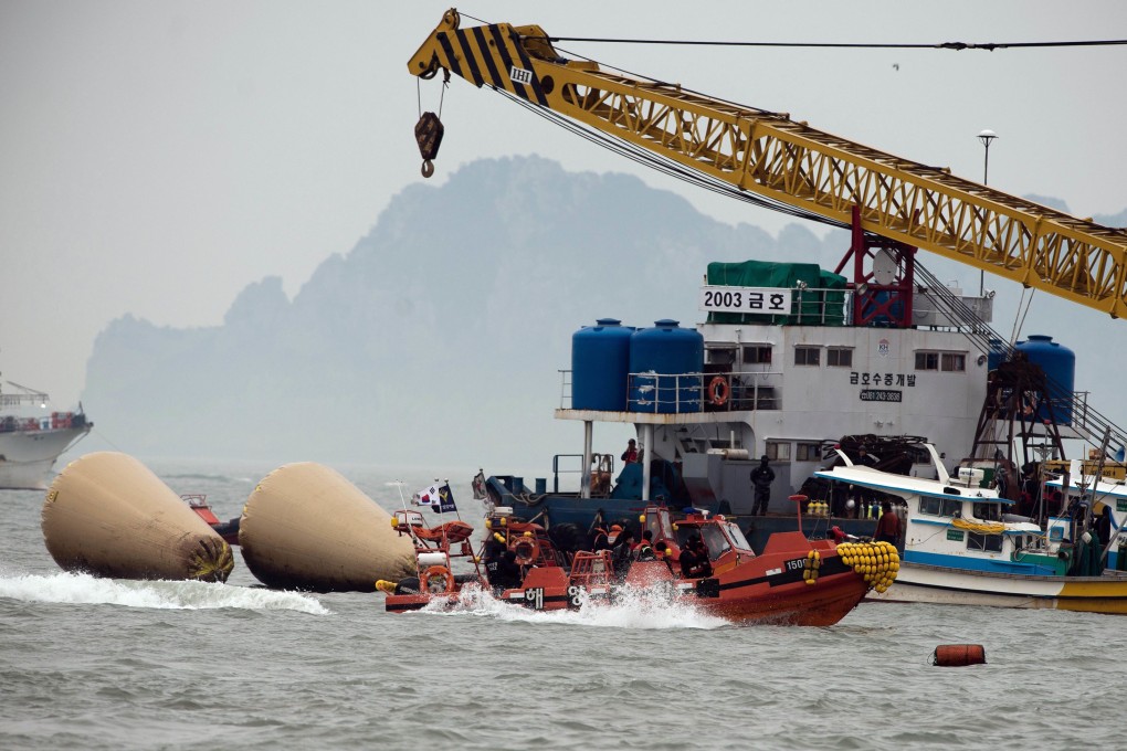 South Korean coast guards and rescue workers are seen at the accident site of the capsized South Korean ferry Sewol in Jindo. Photo: AFP