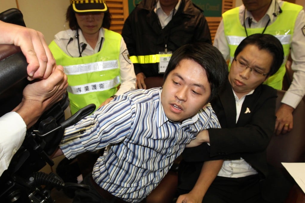 Security guards prepare to try to remove district councillor Ted Hui (left) and his Democratic Party colleague Ng Siu-hong. Photo: Dickson Lee