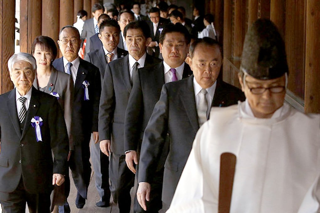 Japanese lawmakers led by a Shinto priest visit the Yasukuni Shrine in Tokyo on Tuesday. Photo: Reuters