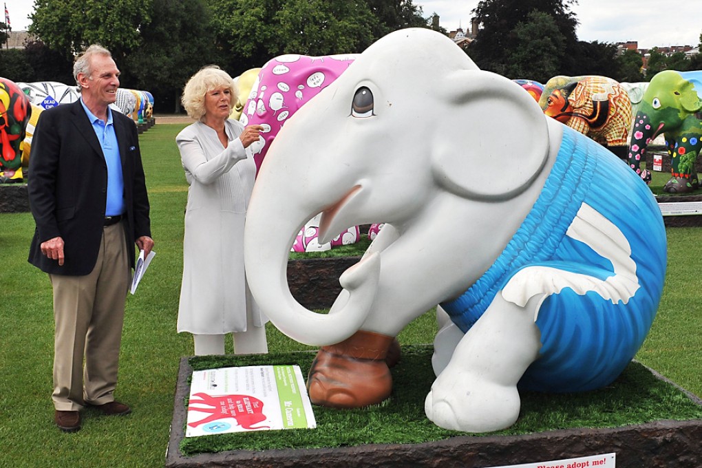Camilla (right) accompanied by her brother Mark Shand, is shown an elephant sculpture titled 'Mr Cameron' during a visit to the 'Elephant Parade' exhibition at Chelsea Hospital Gardens, in London in 2010. Photo: AFP