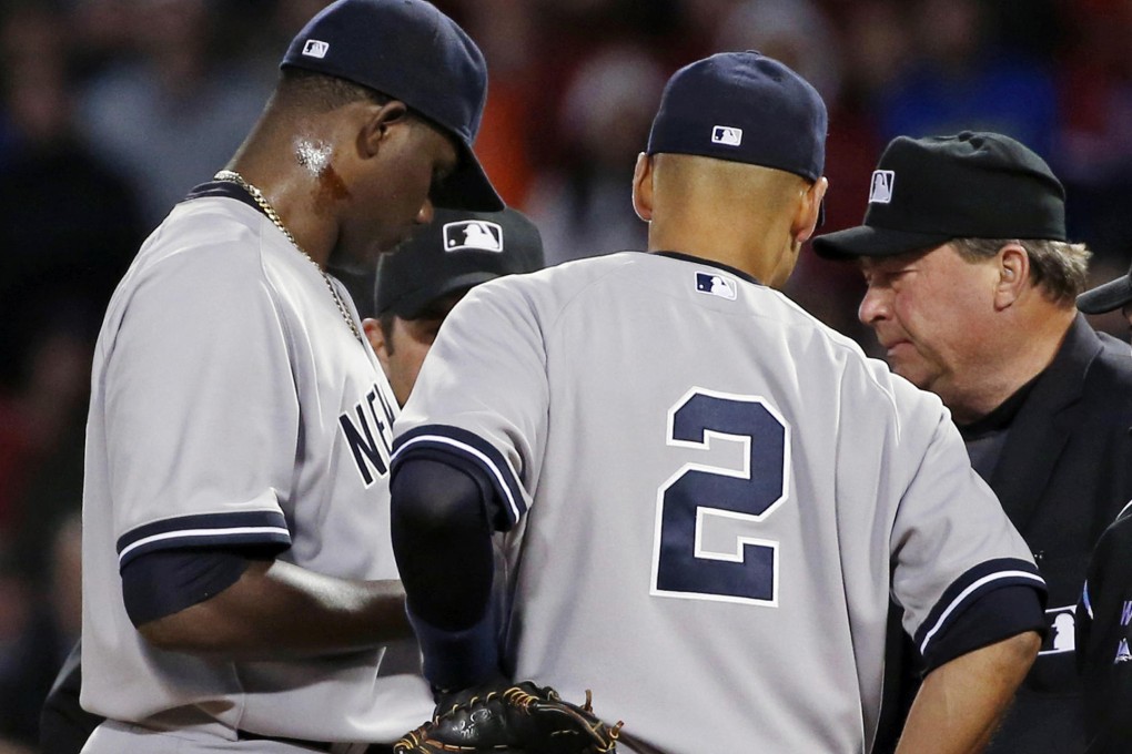 The pine tar can clearly be seen on the neck of Michael Pineda (left). Photo: AP