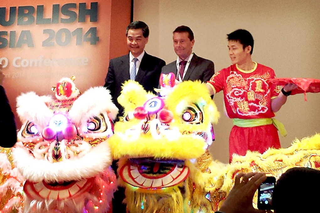 Chief executive Leung Chun-ying joins WAN-IFRA president Tomas Brunegård on stage to open the annual Publish Asia international conference. Photo: Joanna Chiu