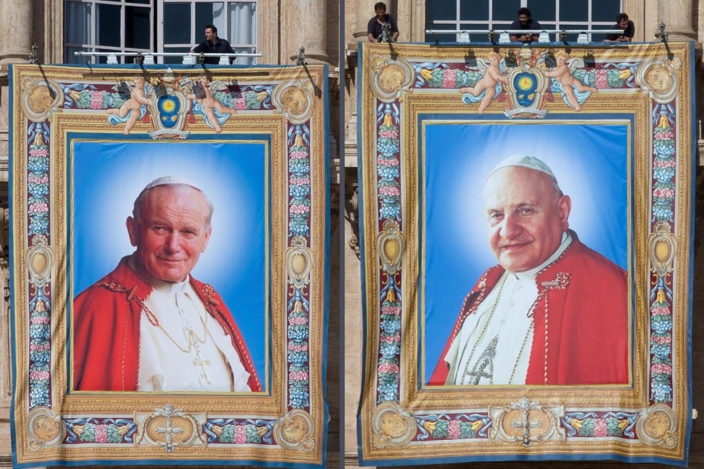 A composite photo shows the tapestry portraits of former Popes John Paul II, left, and John XXIII hanging in St Peter's Square, prior to Sunday's historic ceremony. Photo: EPA