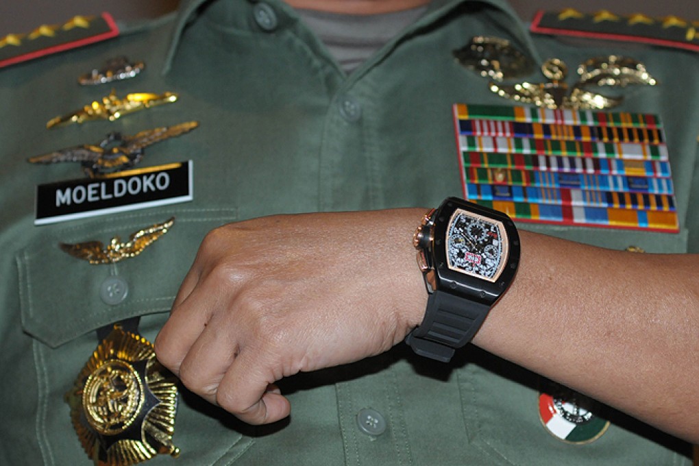 Indonesian military chief General Moeldoko shows his luxury watch, which he claims is a Chinese-made fake, to journalists in Jakarta. Photo: AFP