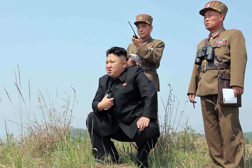A picture from a North Korean newspaper shows state leader Kim Jong-un observing a firing drill by a women's artillery unit in Kangwon province. Photo: EPA