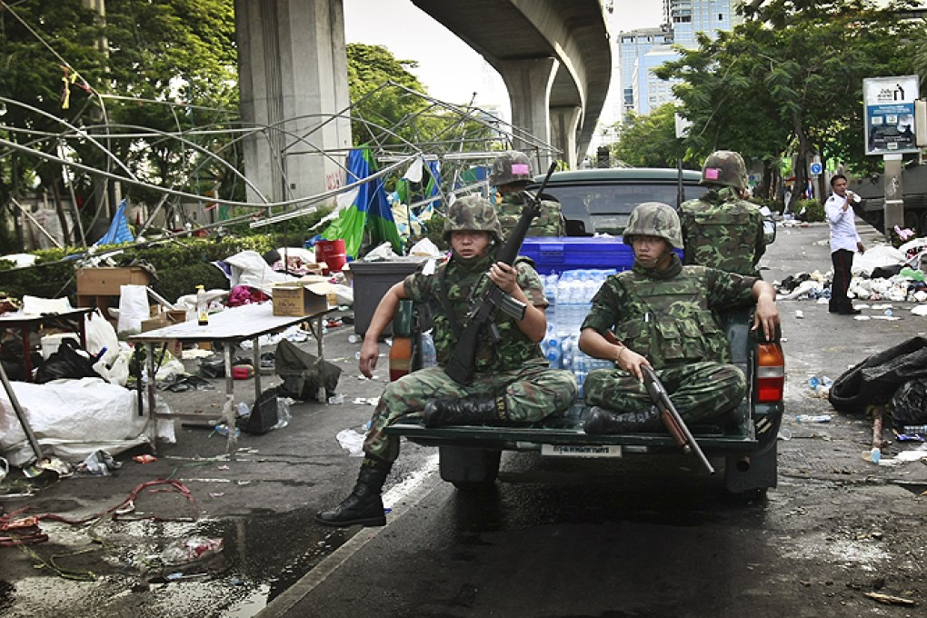 Thai soldiers ride through an area of Bangkok formerly held by anti-government protesters. Photo: AP