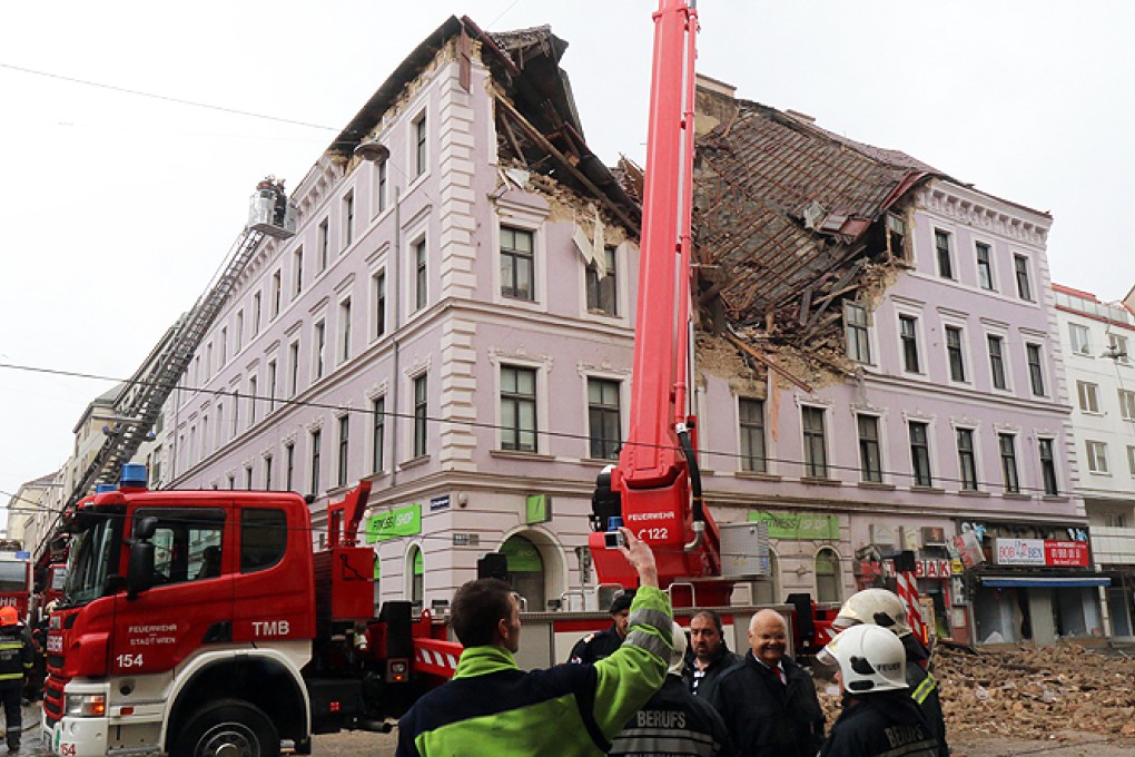 Firefighters and police at a building damaged by an explosion in Vienna, Austria, on Saturday. Photo: AP