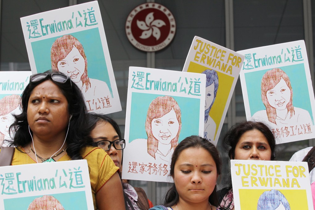 Domestic helpers display posters of alleged abuse victim Erwiana Sulistyaningsih as the petition is handed in at Tamar. Photo: Edward Wong