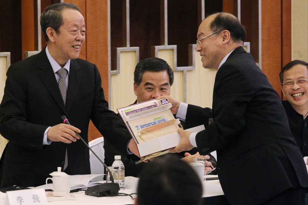 Legislator Frederick Fung Kin-kee (right) presents a model of the proposed three-track nomination system to Wang Guangya during a meeting for legislators in Shanghai.