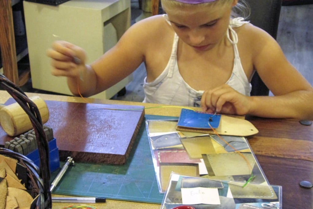 Learning leatherwork skills at Ah Moon.