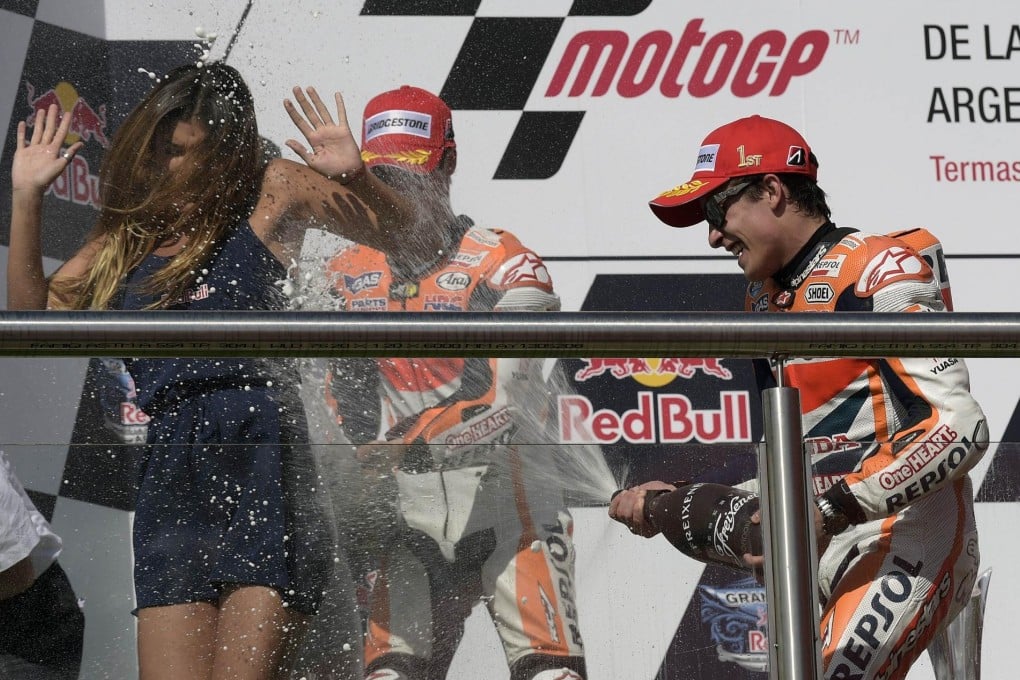 Marc Marquez breaks out the champagne on the podium after winning the MotoGP race of the Argentina Grand Prix at Termas de Rio Hondo circuit in Santiago del Estero. Photo: AFP