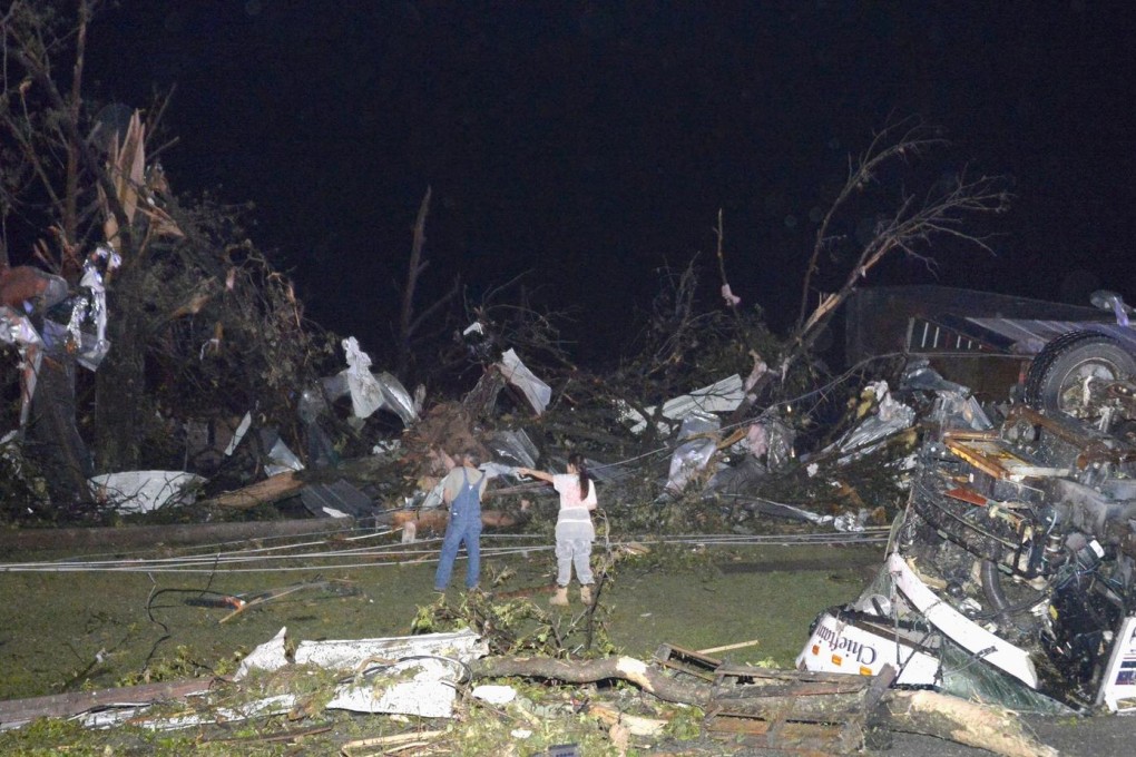 Business owners check the massive damage left behind in Mayflower, Arkansas, after tornadoes ripped through south-central of the US. Photo: Reuters