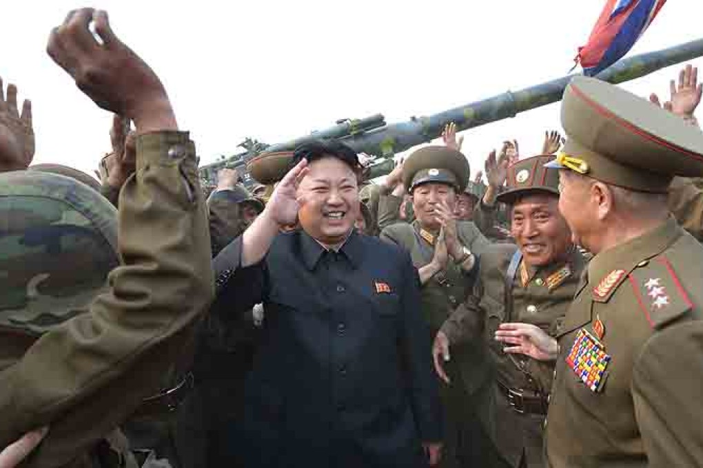 North Korea's leader Kim Jong-un with soldiers of a long-range artillery unit during a firing drill at an undisclosed location. Photo: EPA