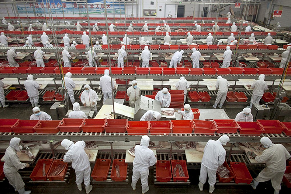 Workers at a pork processing plant owned by Shuanghui International, which bought the American firm Smithfield Foods. Photo: AP