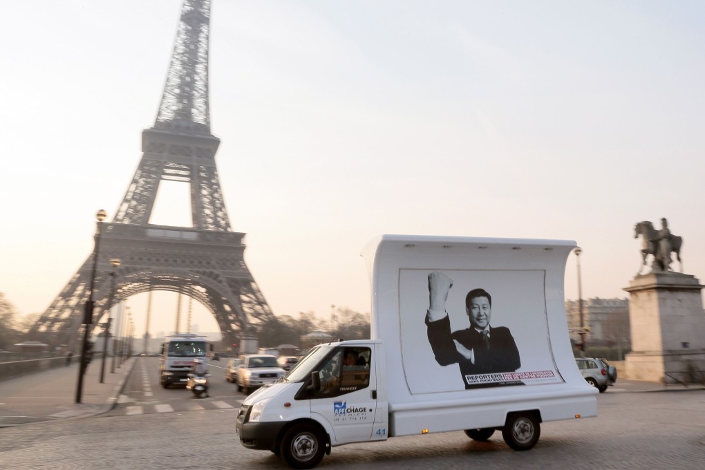 A truck, displaying a portrait of President Xi Jinping, passes near the Eiffel Tower on in Paris in March as part of a demonstration by Reporters Without Borders. Source: AFP