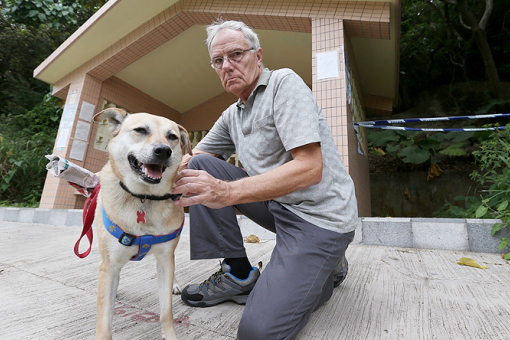 John Wedderburn with his dog Sally. The retired doctor plans to leave the city after another pet, Coffee, was poisoned. Photo: Nora Tam