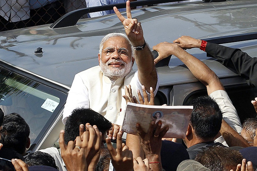 Hindu nationalist Narendra Modi gestures to his supporters after casting his vote in Ahmedabad. Photo: Reuters