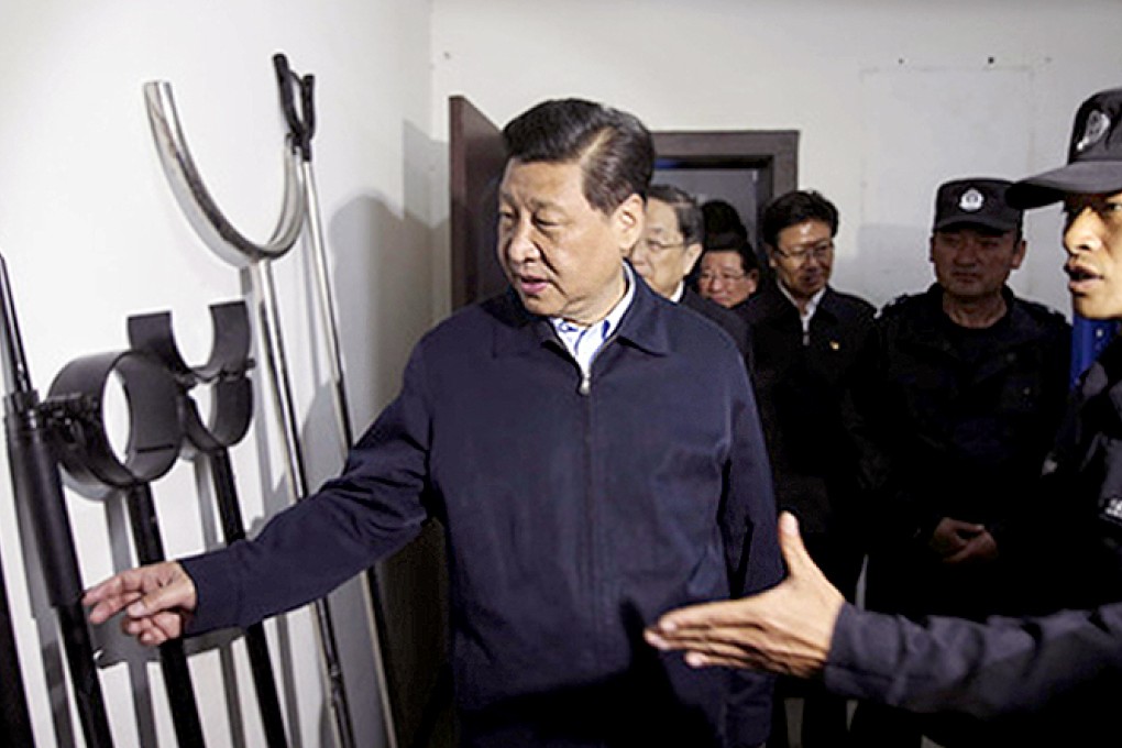 President Xi Jinping inspects weapons used by officers to halt violent unrest on a visit to a police station in Kashgar. Photo: Xinhua