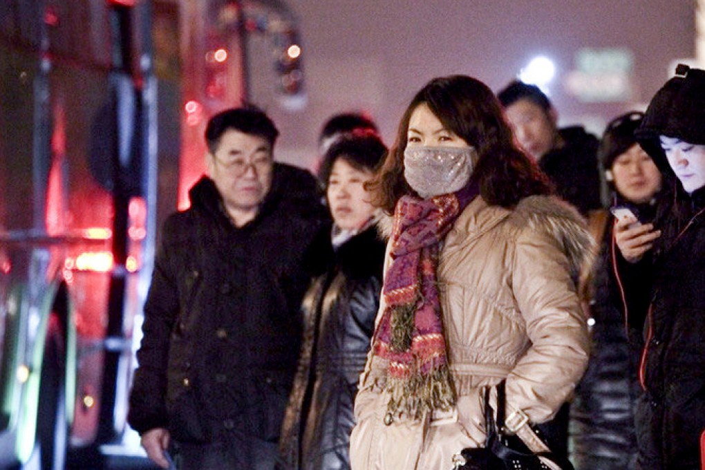 Commuters queue for buses heading to Beijing early in the morning.
