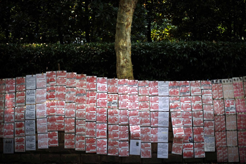 Singles seeking spouses post their profiles in People's Square in Shanghai, a sign of the problems faced by career women on the mainland.Photo: Reuters