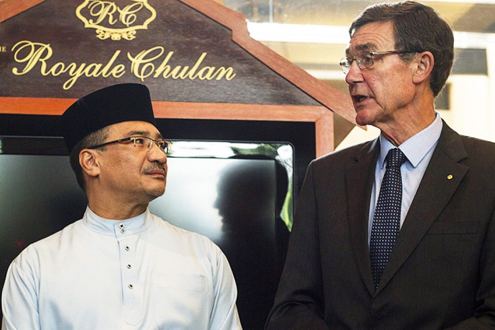 Malaysian Defence Minister Hishammuddin Hussein listens to Angus Houston, the Australian head of the search, in Kuala Lumpur on Friday. Photo: EPA
