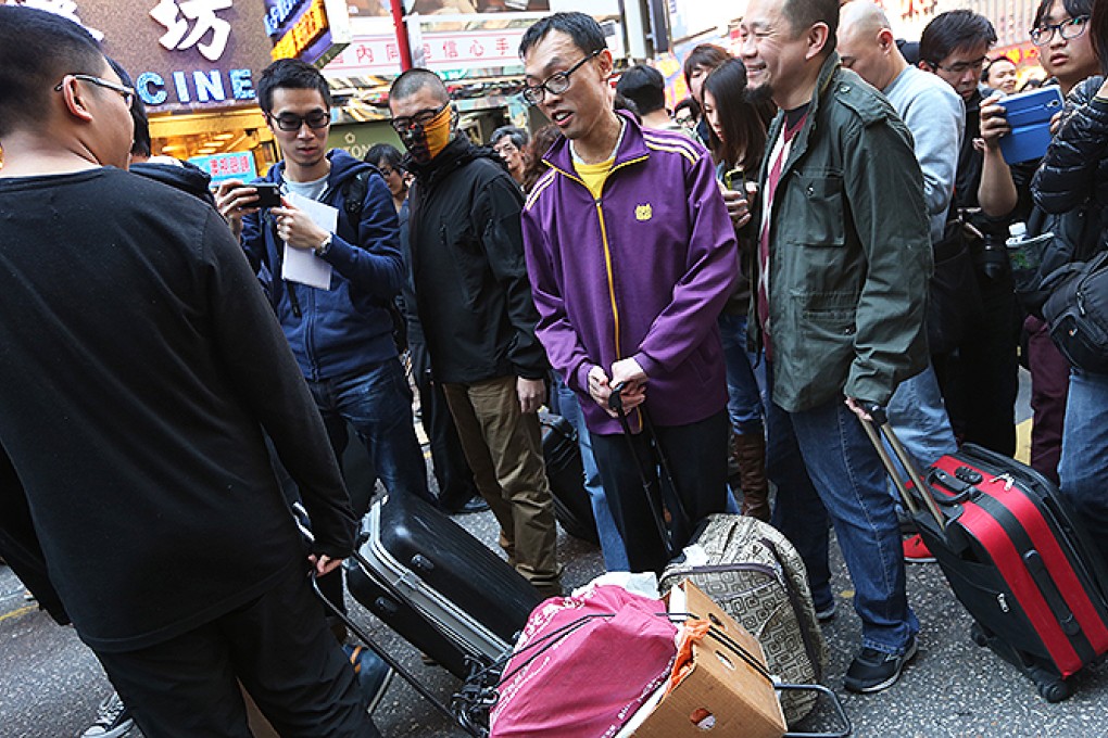 Activists pull luggage in their sarcastic protest in Mong Kok. Photo: David Wong