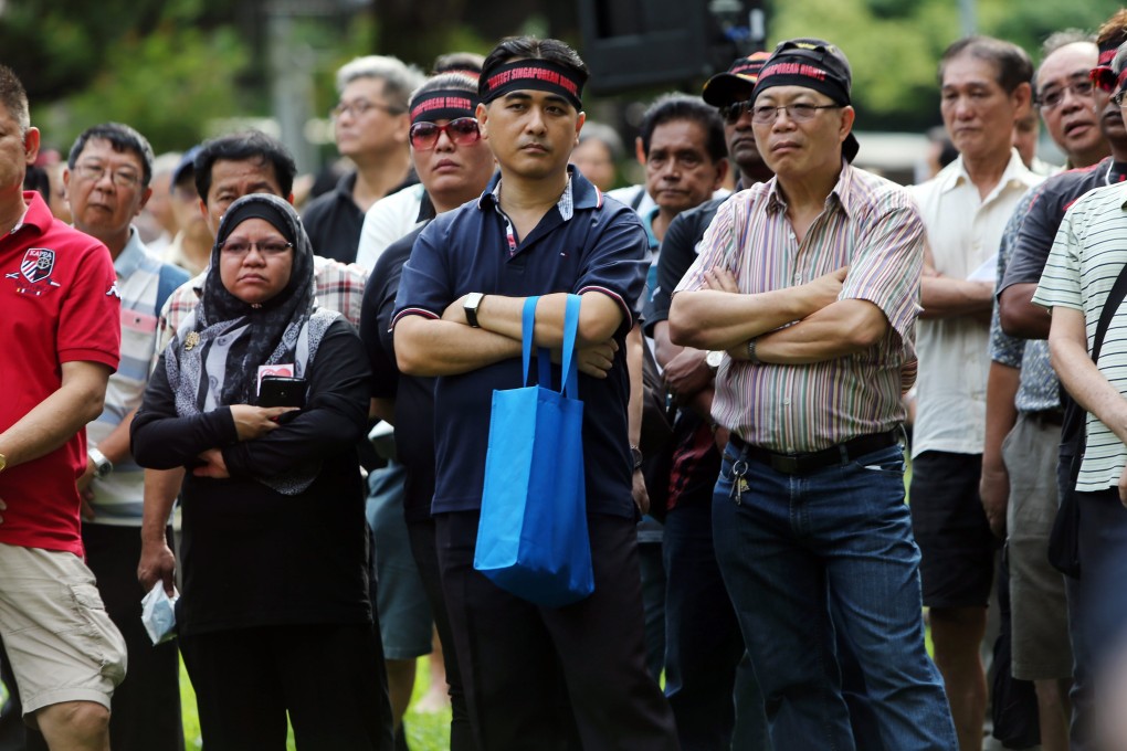 Protesters, estimated to number around 400, wore black headbands with the words "Protect Singaporean Rights" in red as they chanted slogans against the long-ruling People's Action Party. Photo: EPA