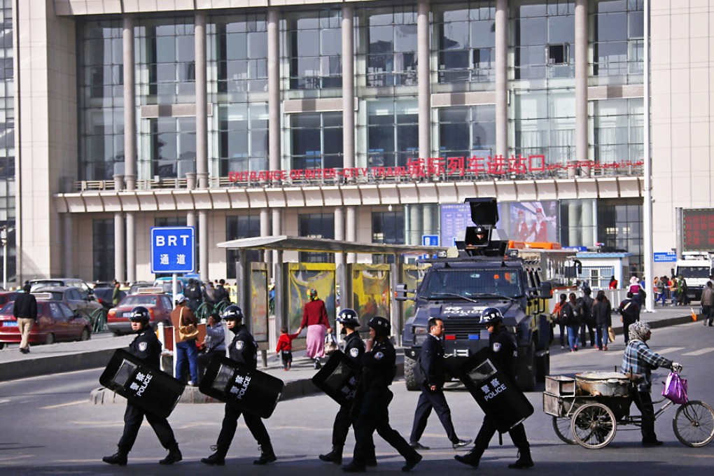 Armed police patrol the entrance of the Urumqi South railway station, where a suicide attack killed one and injured 79 on Wednesday night. Photo: Reuters