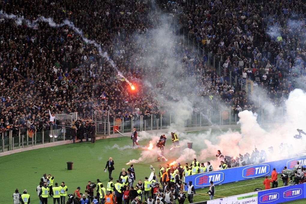 Napoli fans throw flares before the kick-off. Photo: AP