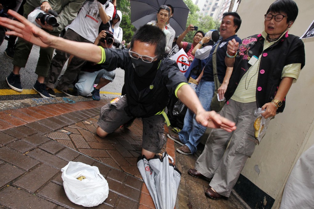 Protesters outside the home of Gregory So pretended to defecate and urinate. Photo: Dickson Lee