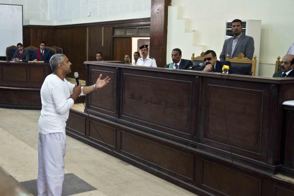 Defendant Mohamed Fahmy talks to the judge. Photo: AP
