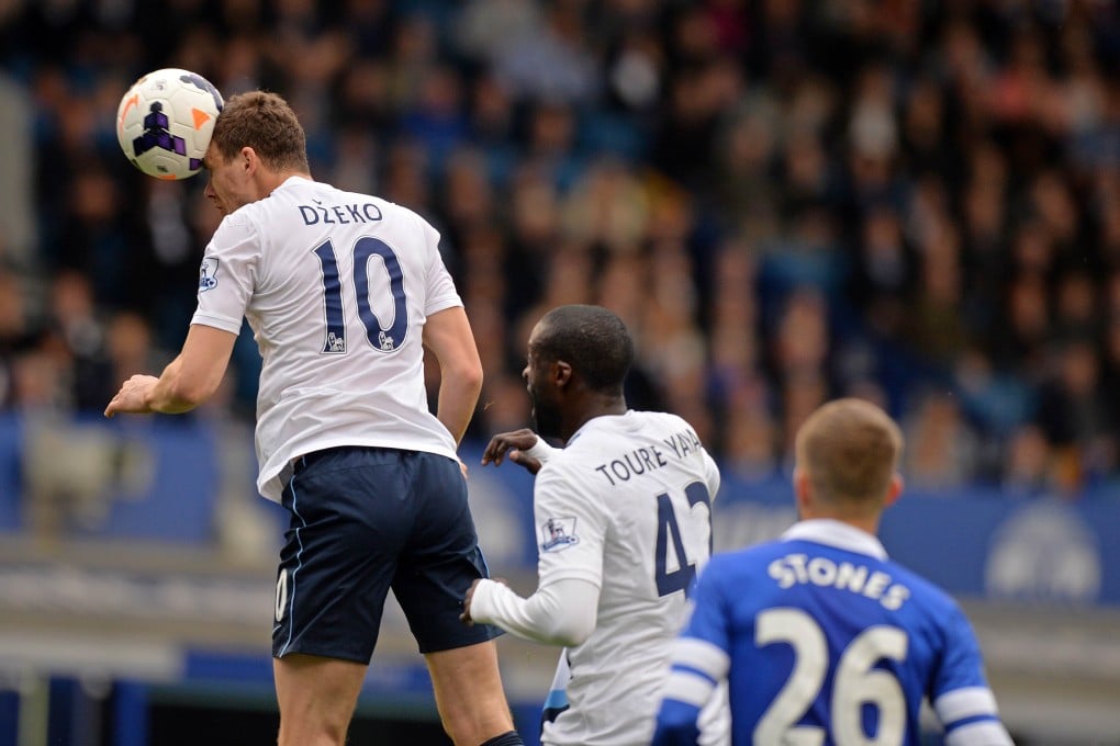 Bosnian striker Edin Dzeko heads the ball to score Manchester City's second goal in their match against Everton at Goodison Park. Photo: AFP
